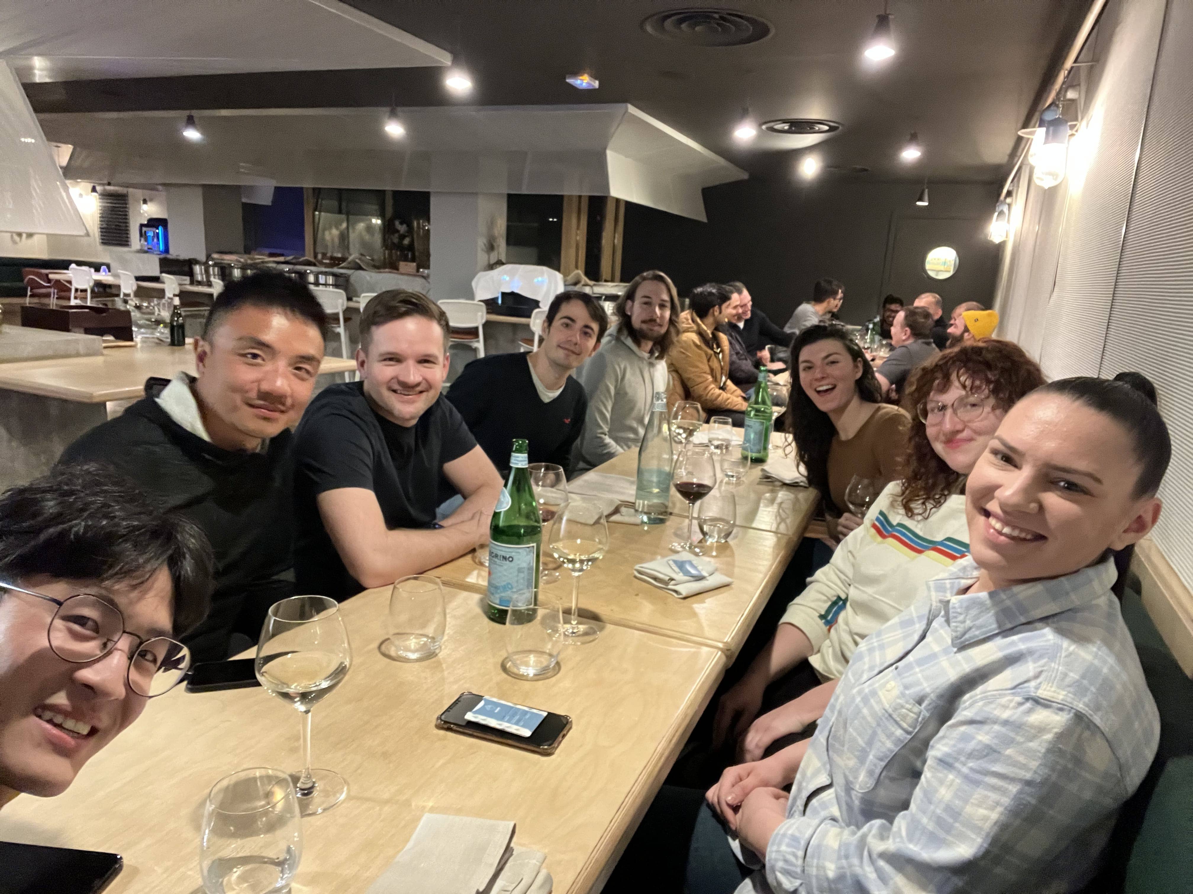 Members of the MUI team sitting around a large wooden dining table.